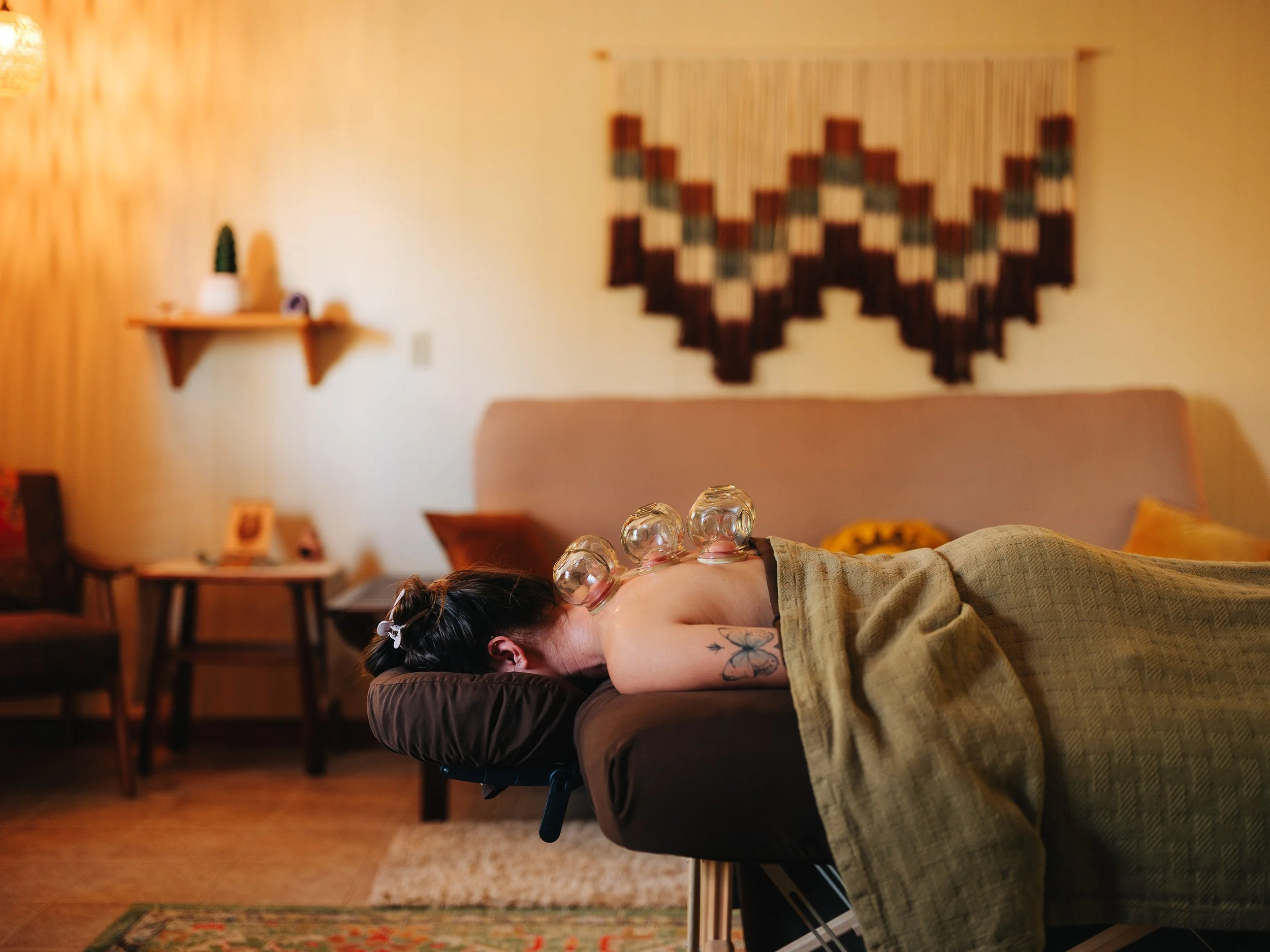 Cupping therapy session with glass cups on back at Zen Fox Healing Arts in Asheville NC