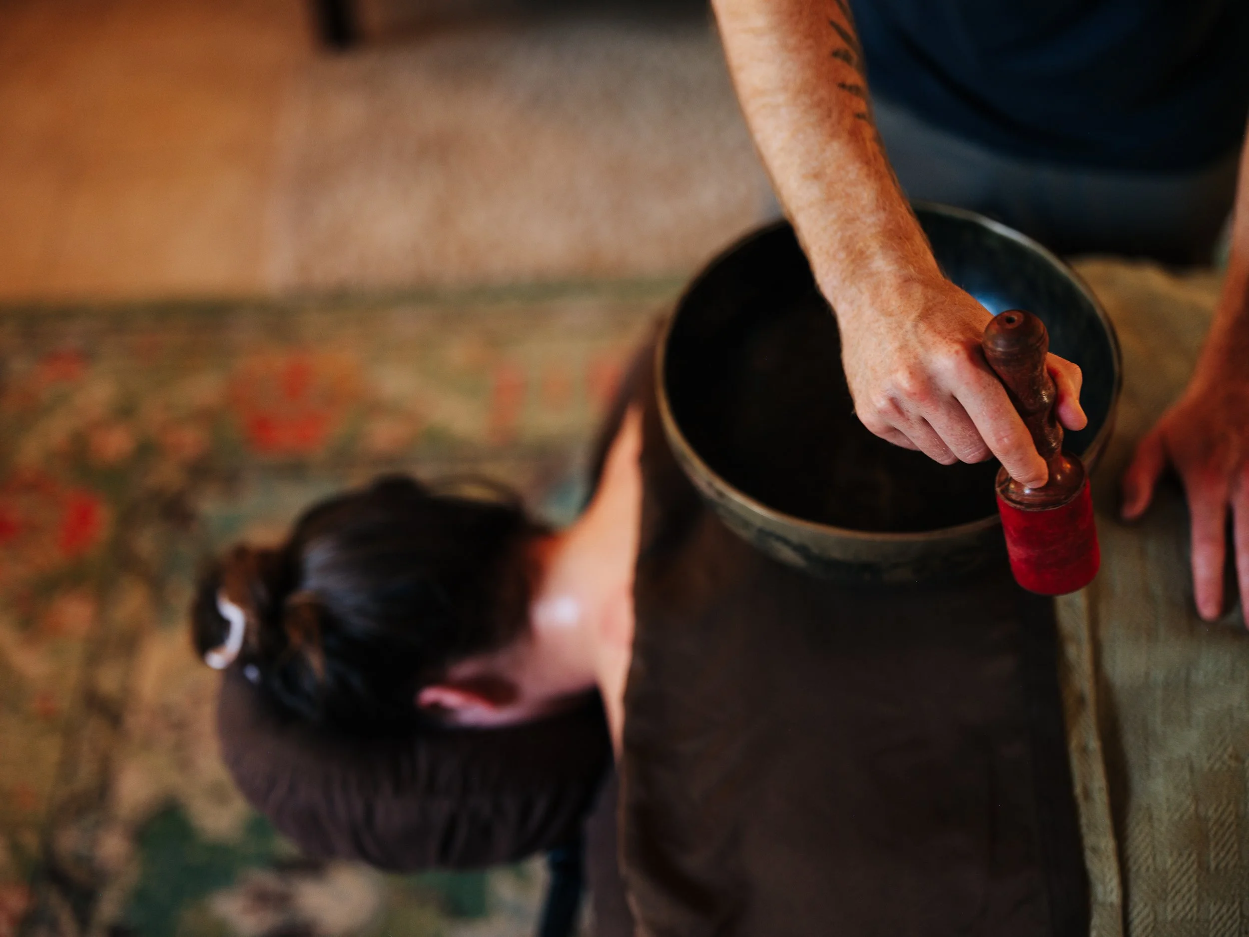 Sound healing with singing bowl during massage session at Zen Fox Healing Arts Asheville NC